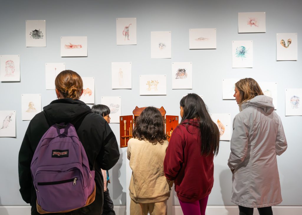 Gallery Visitors Viewing Art Visitors viewing artwork in a gallery space, engaging thoughtfully with the pieces on display.