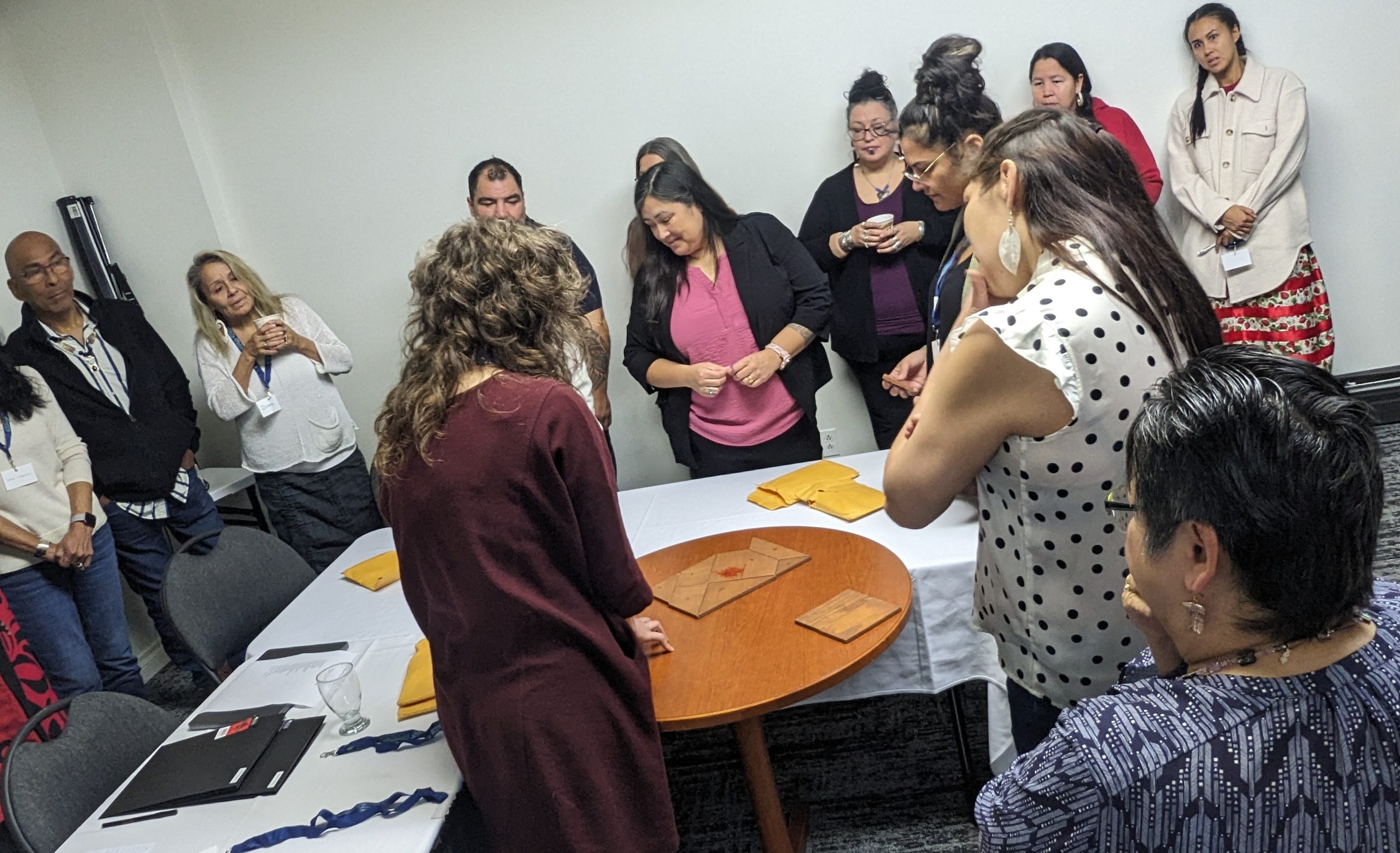 Indigenous Artist Gathering 2023 Broken Squares Participants in the 2023 Indigenous Artist Gathering engage in the Broken Squares activity, collaborating in small groups around tables.