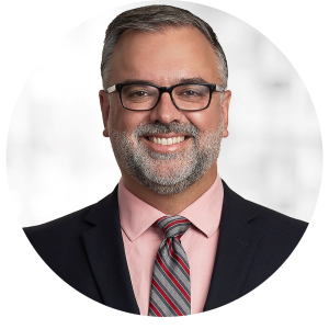 young male headshot in a black suit and a white shirt